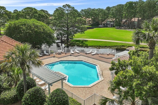 view of pool featuring a lawn and a patio