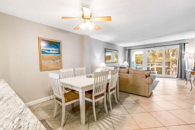 dining area with light tile patterned floors, a textured ceiling, and ceiling fan