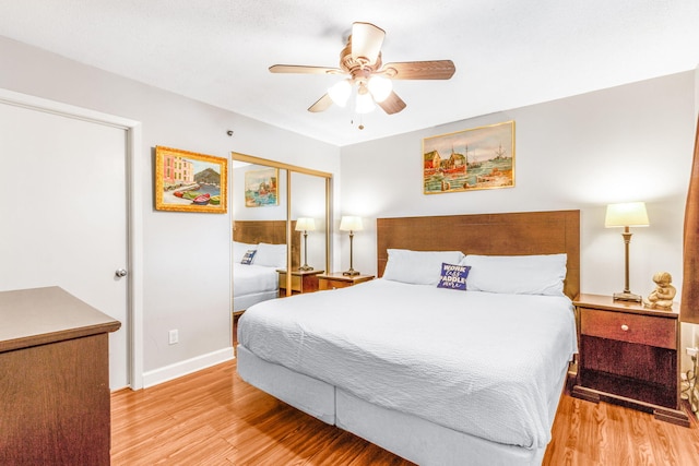 bedroom featuring ceiling fan, light wood-type flooring, and a closet