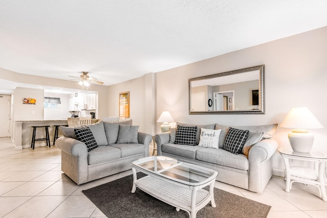 living room featuring ceiling fan and light tile patterned floors