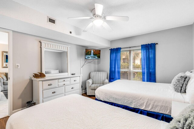 bedroom with hardwood / wood-style floors and ceiling fan