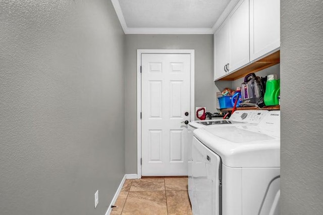 laundry area featuring cabinets, crown molding, washer and dryer, and light tile patterned flooring