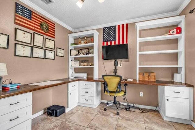 tiled home office with built in desk, a textured ceiling, and ornamental molding