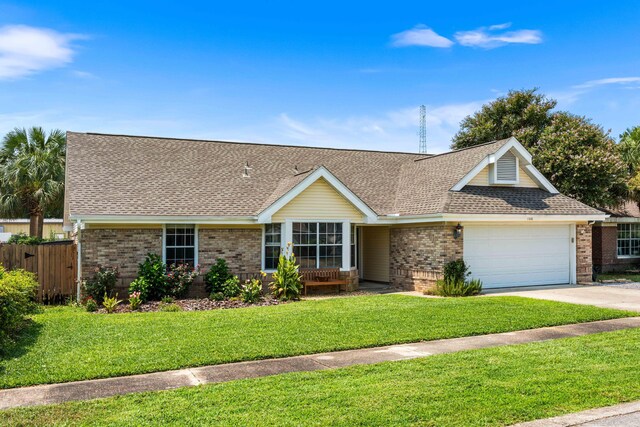 ranch-style house featuring a front yard and a garage