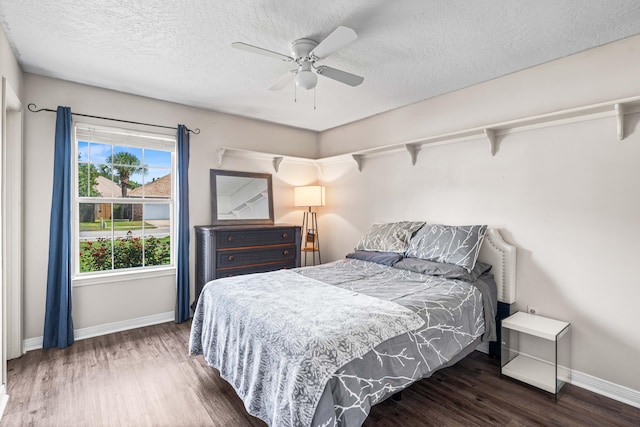 bedroom with a textured ceiling, ceiling fan, and hardwood / wood-style flooring