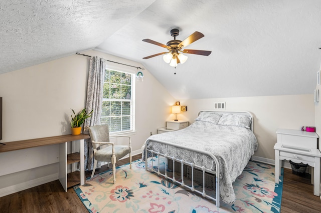 bedroom featuring ceiling fan, vaulted ceiling, a textured ceiling, and dark hardwood / wood-style flooring