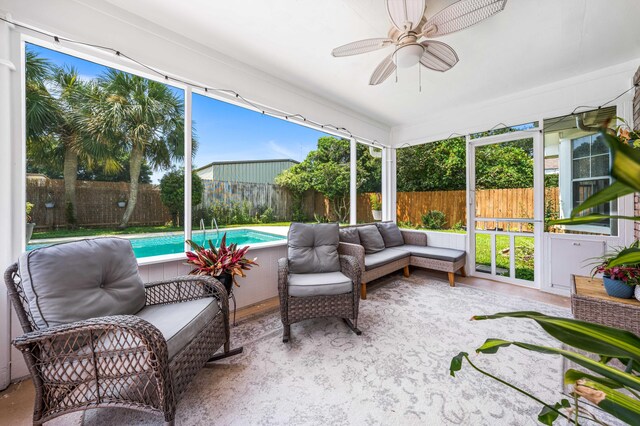 sunroom / solarium featuring plenty of natural light and ceiling fan