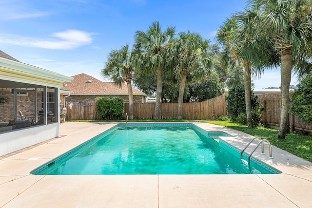 view of swimming pool featuring a patio area and a sunroom