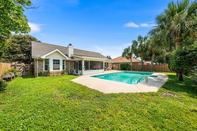 view of pool featuring a patio, a sunroom, and a yard