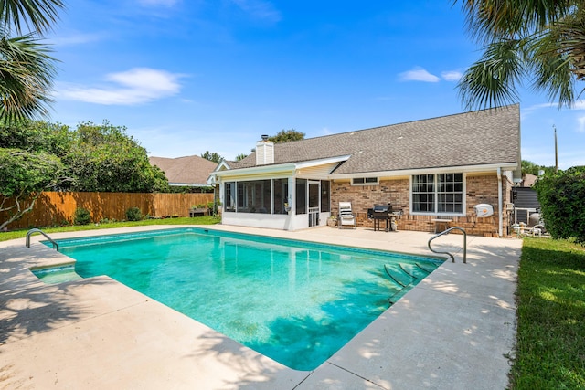 view of pool with a patio area and a sunroom