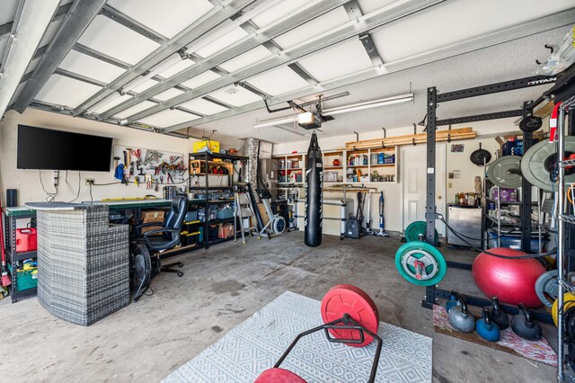 garage with a garage door opener and a workshop area