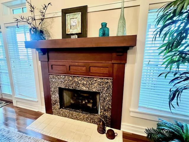 interior details featuring hardwood / wood-style flooring and a premium fireplace