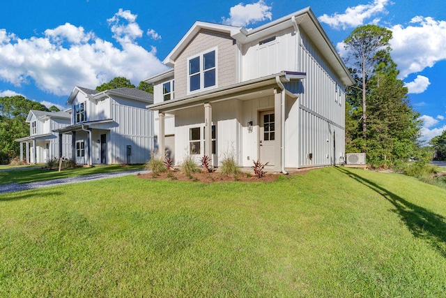 view of front of home with board and batten siding and a front yard