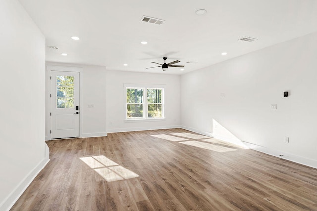 unfurnished living room with light wood-type flooring, plenty of natural light, visible vents, and recessed lighting