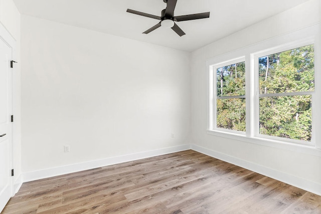 unfurnished room featuring light wood-type flooring, ceiling fan, and baseboards