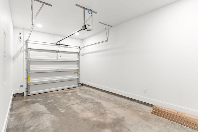 garage with baseboards and a garage door opener