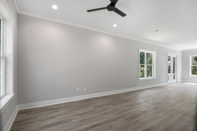 spare room featuring ornamental molding, dark wood-type flooring, recessed lighting, and baseboards