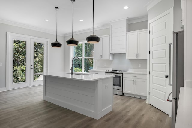 kitchen with a kitchen island with sink, a sink, white cabinets, light countertops, and appliances with stainless steel finishes