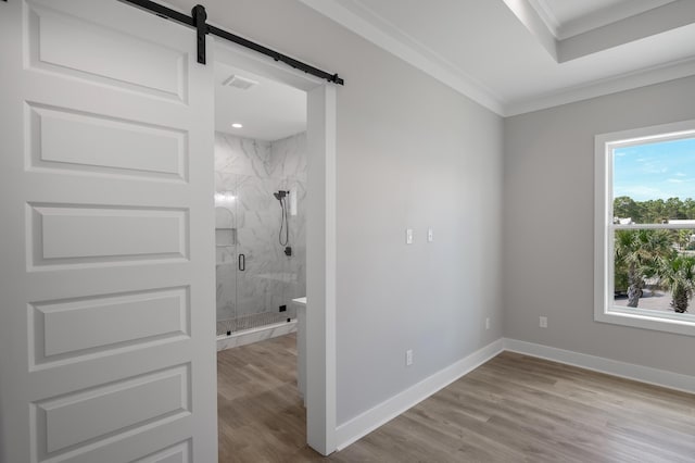 full bathroom with a marble finish shower, baseboards, crown molding, and wood finished floors