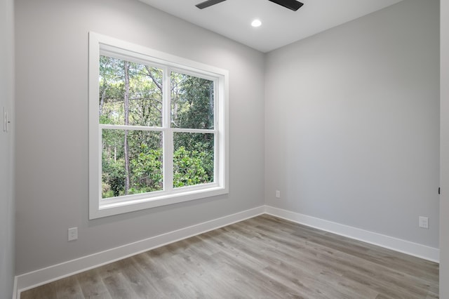 empty room with light wood finished floors, baseboards, a ceiling fan, and recessed lighting