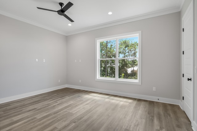 unfurnished room with plenty of natural light, crown molding, and baseboards