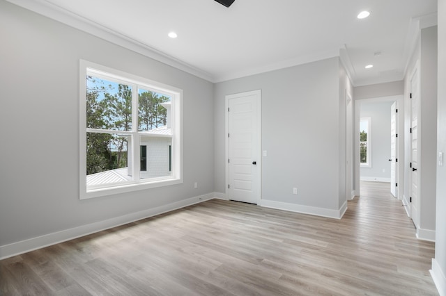 unfurnished room featuring ornamental molding, light wood-type flooring, baseboards, and recessed lighting