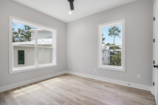 unfurnished room with light wood-type flooring, baseboards, a ceiling fan, and recessed lighting