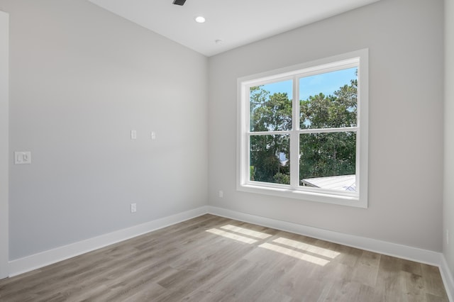 empty room with recessed lighting, ceiling fan, light wood finished floors, and baseboards