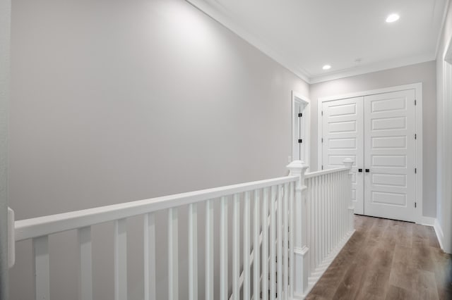 hallway with ornamental molding, wood finished floors, and recessed lighting