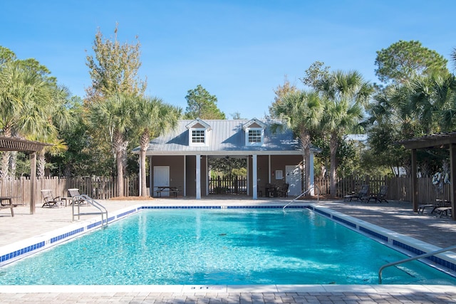 pool featuring fence and a patio