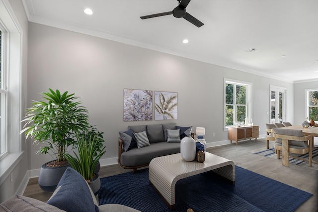 living room with light wood finished floors, baseboards, ceiling fan, ornamental molding, and recessed lighting