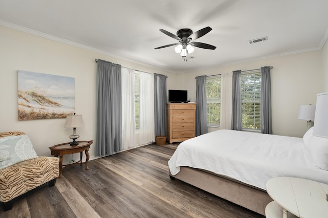 bedroom featuring ceiling fan, crown molding, and dark hardwood / wood-style floors