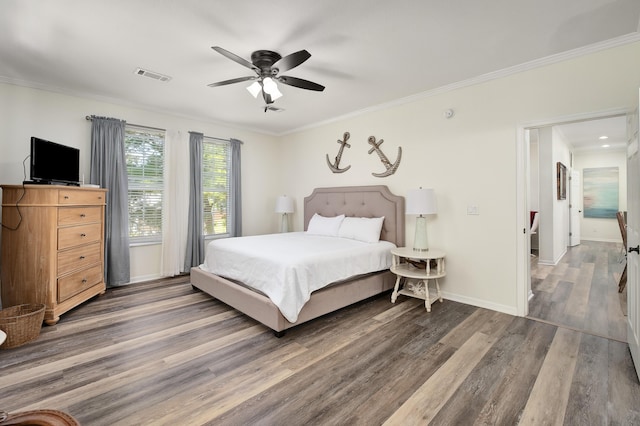 bedroom featuring ornamental molding, dark wood-type flooring, and ceiling fan