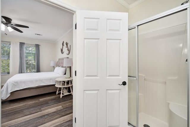 bedroom featuring wood-type flooring, ceiling fan, a closet, and crown molding