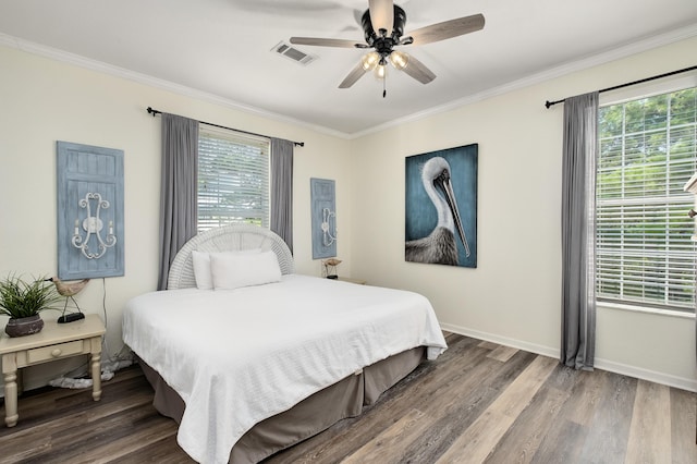 bedroom featuring multiple windows, crown molding, and dark hardwood / wood-style flooring