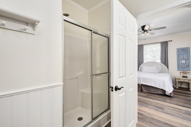 bathroom with hardwood / wood-style flooring, walk in shower, crown molding, and ceiling fan