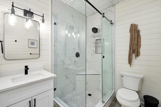 bathroom with toilet, a shower with door, wooden walls, and vanity