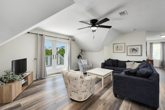 living room with ceiling fan, vaulted ceiling, wood-type flooring, and french doors