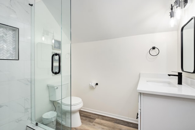 bathroom featuring wood-type flooring, toilet, an enclosed shower, vaulted ceiling, and vanity