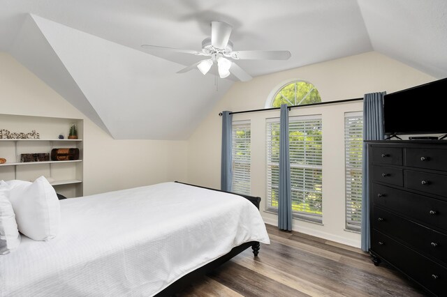 bedroom featuring ceiling fan, vaulted ceiling, and dark hardwood / wood-style flooring