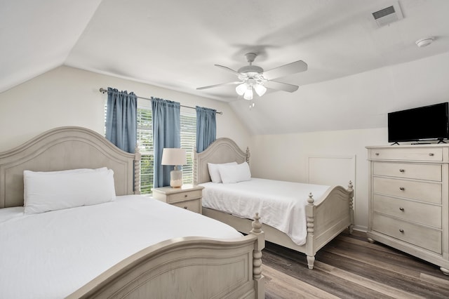 bedroom with dark hardwood / wood-style flooring, ceiling fan, and vaulted ceiling