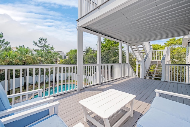 wooden terrace with a fenced in pool