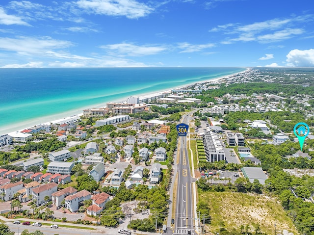 birds eye view of property featuring a water view and a beach view