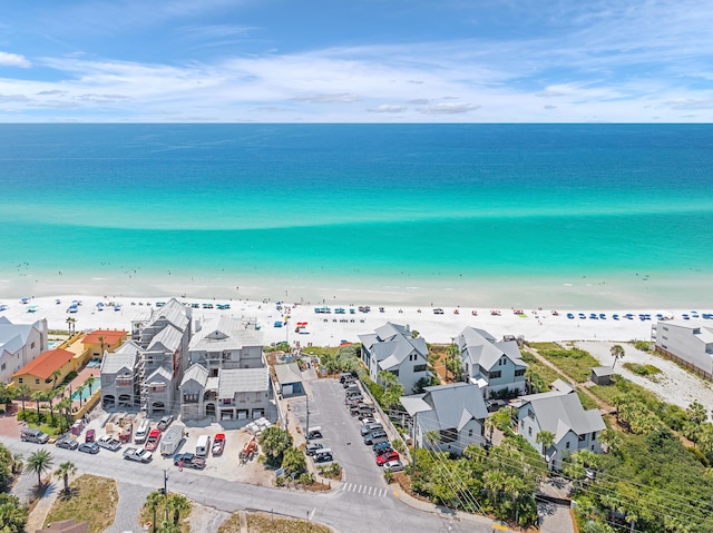 drone / aerial view featuring a water view and a beach view