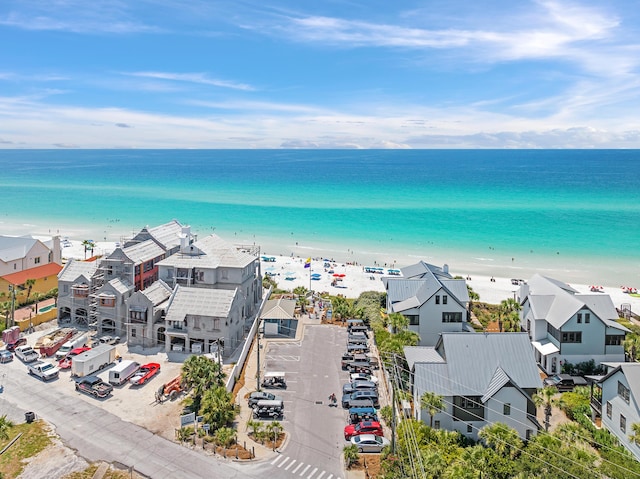 birds eye view of property featuring a beach view and a water view