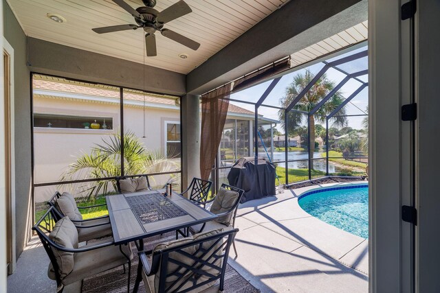 view of pool featuring a lanai, ceiling fan, and a patio area