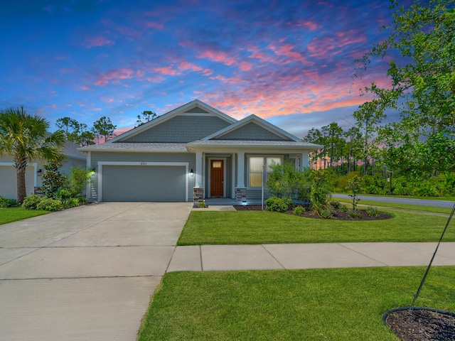 craftsman-style house with a yard and a garage