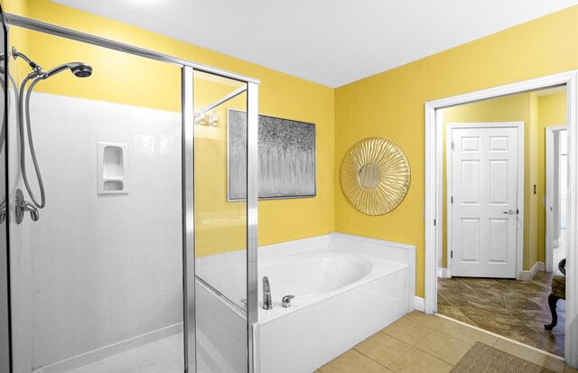 bathroom with tile patterned flooring and independent shower and bath