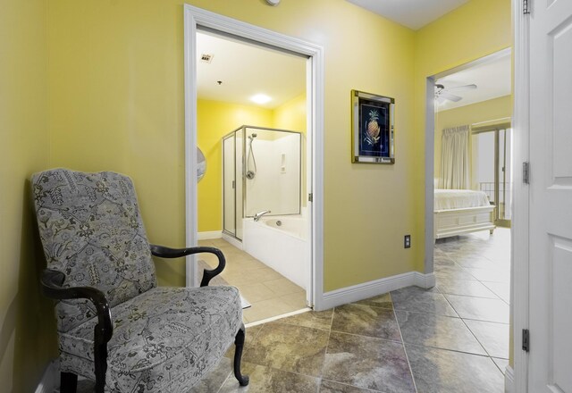 living area with tile patterned flooring and ceiling fan