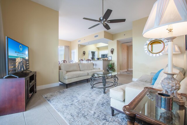 tiled living room featuring ceiling fan